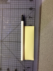 roll piece of tape onto pen leaving room for the cap 