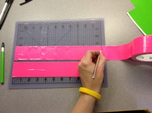 roll tape onto mat and use knife to cut every 8 inches