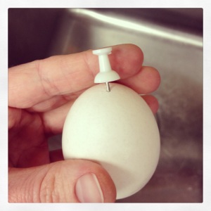Poke a hole in the egg with a thumbtack.